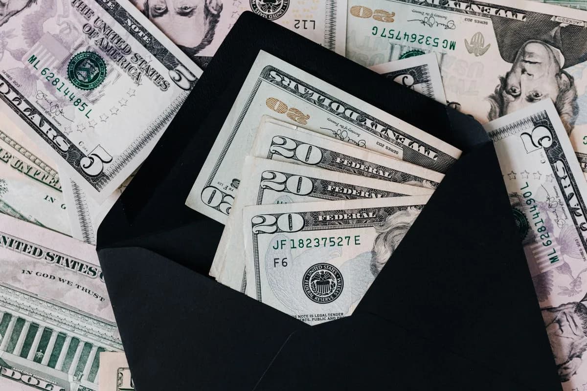 Cash in an envelope representing the cost of septic service